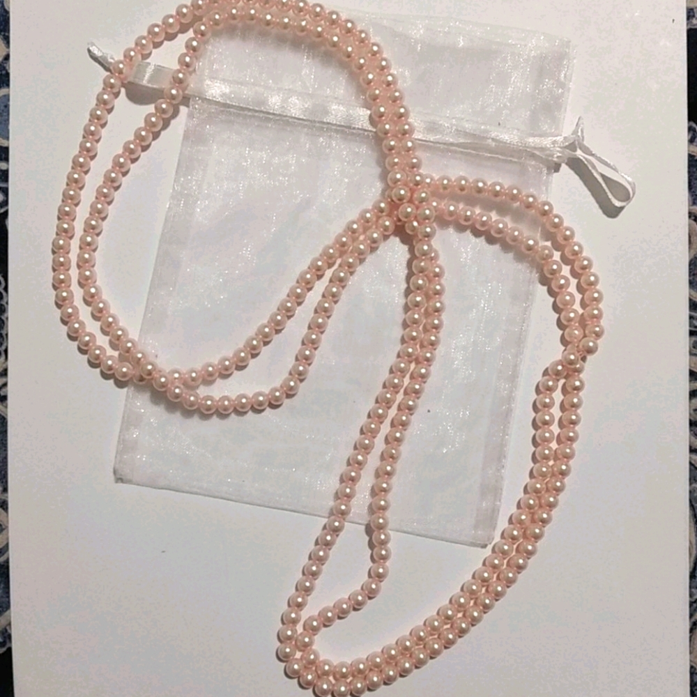 Long strand of pink pearl style beads
